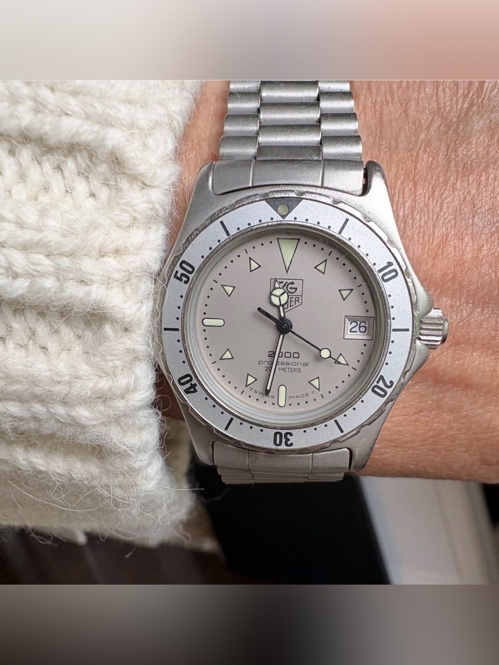TAG Heuer 2000 Series Professional watch, features a silver-tone case cream dial